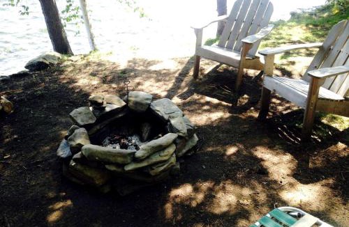 Brownville House | Charming Lakefront Cabin Rental with a Fire Pit near Brownville, Maine