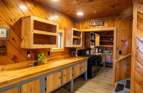 Northeast Somerset Cabin | Katahdin - Cabin 4 · Lawrence`s Lakeside Cabins | `Katahdin`: Boat Dock + Kayaks