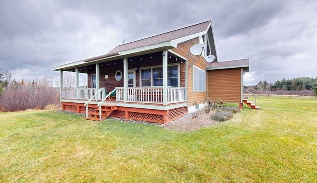 Cozy, dog-friendly waterfront cabin with large yard, porch, dock, & lake views