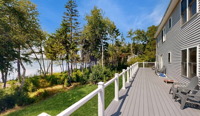 Elegant, spacious coastal home with sunset ocean views from an inviting deck
