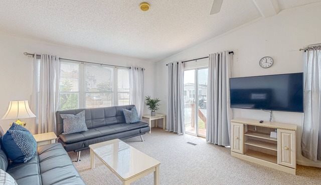 Sunny coastal home with private patio, on-site pool, central AC, & W/D