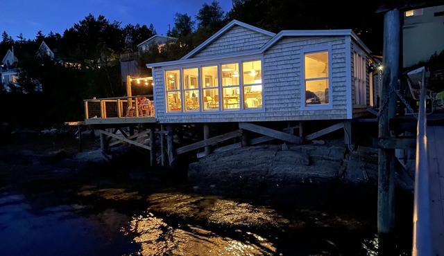 Waterfront, west facing, modernized fisherman’s cottage perched on the water.