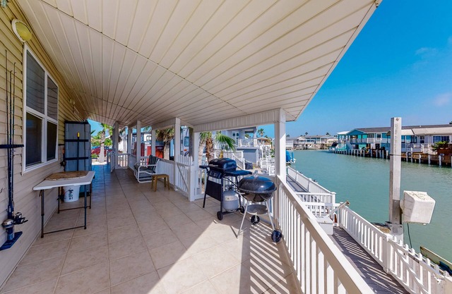 Waterfront home with views of channel, expansive covered deck, & 2 pools